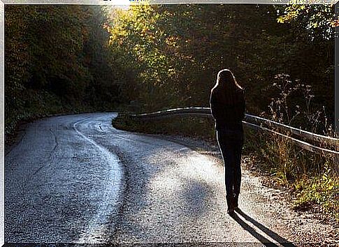 Woman walking alone on the road