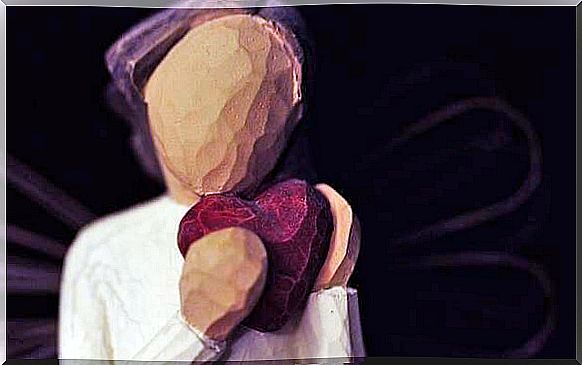 Wooden figure holds heart