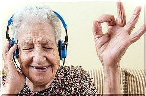 Elderly person listens to music and smiles, which shows that actually singing makes us happier