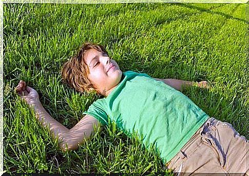 Boy on grass is relaxed and in control of his emotions