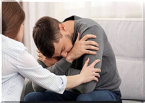 Woman trying to comfort despairing man