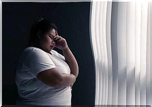 Overweight woman by window