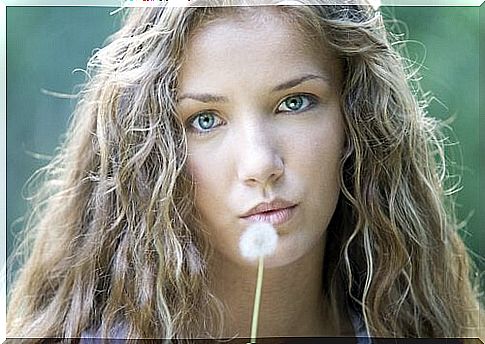 Woman breathing for dandelion