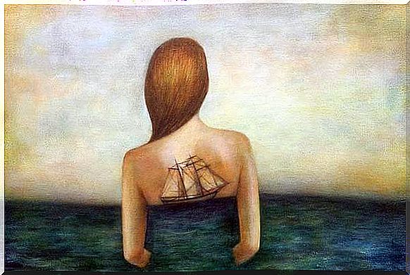 Woman in sea with boat on back