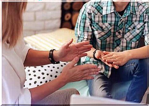 Two people talking together and using their hands 