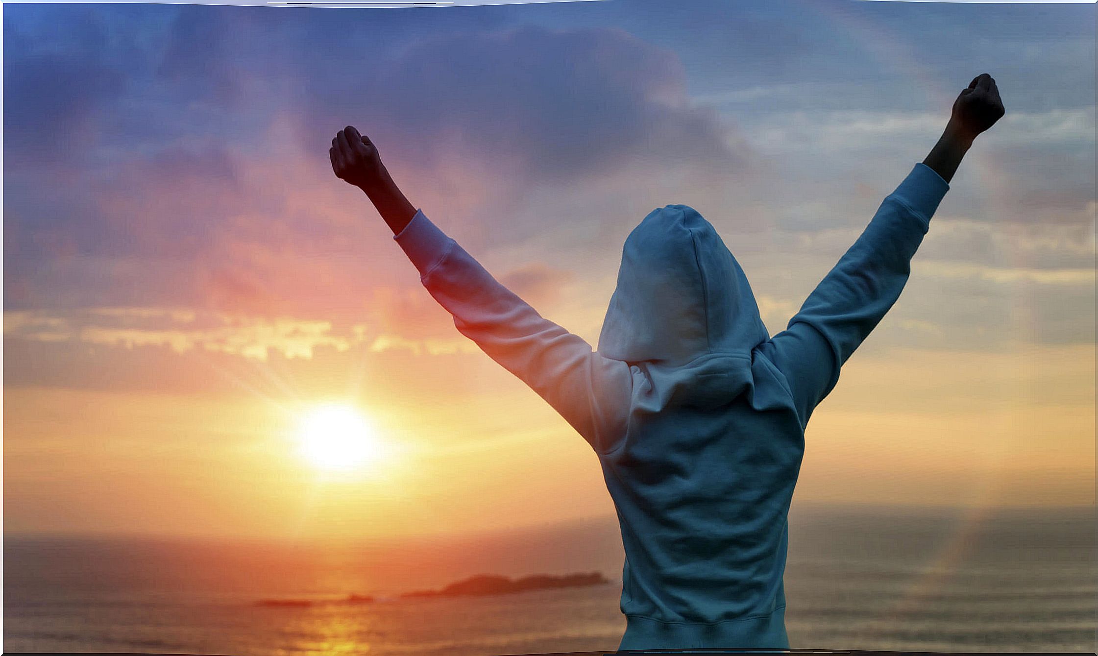 Person with arms raised above his head has managed to find the motivation