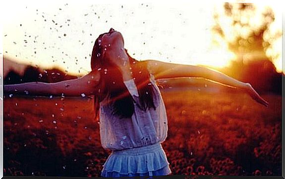 a girl with her hands out to the side in landscape