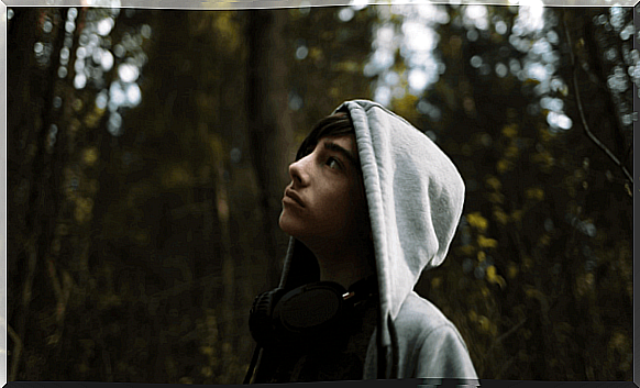 Young teenager in forest wearing hoodie