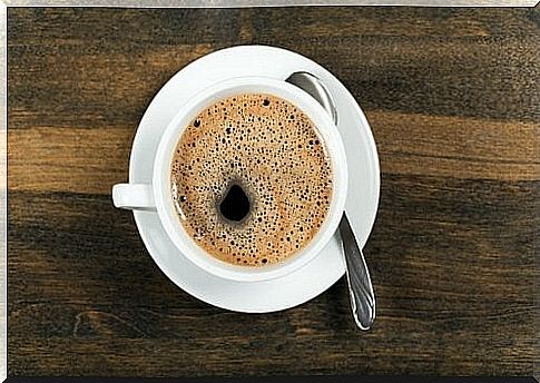 a cup of coffee on a wooden table