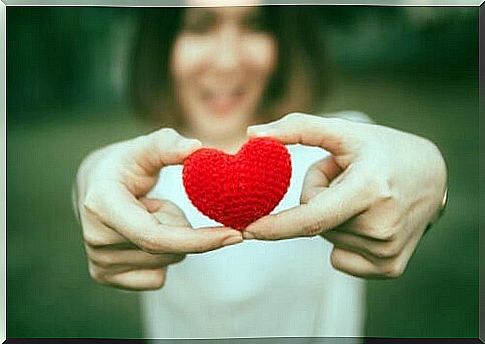 Woman holding a red heart 