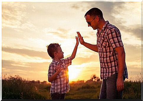 Father and son give high five