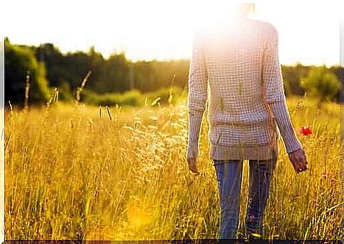 Woman walking on flower meadow