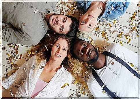 Friends lying on the ground with their heads together symbolize social entrepreneurship