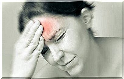 Woman with pain in forehead illustrates migraine