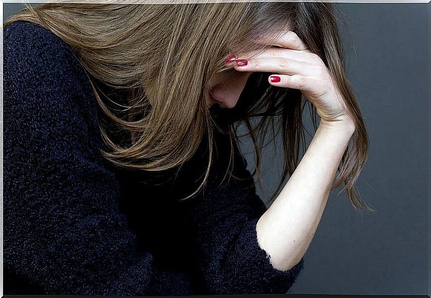 Worried woman takes care of her head, tired of problem solving