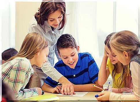 A teacher helps a group of students