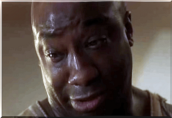 John Coffey in The Green Mile looks down with tears in his eyes