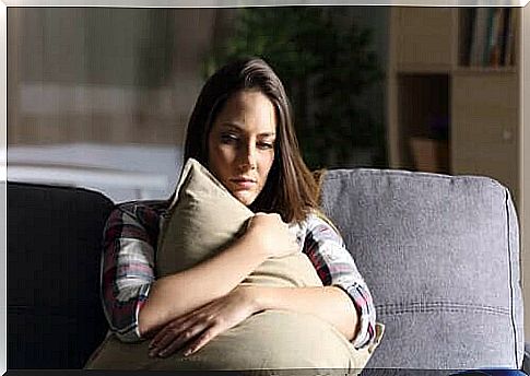 Sad woman hugging a pillow