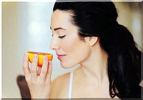 Woman smells of orange