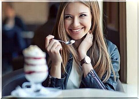 Woman smiling with spoon in hand