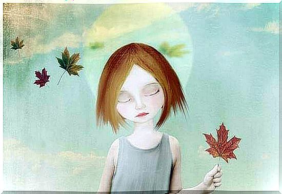 Girl with closed eyes and withered leaf in hand