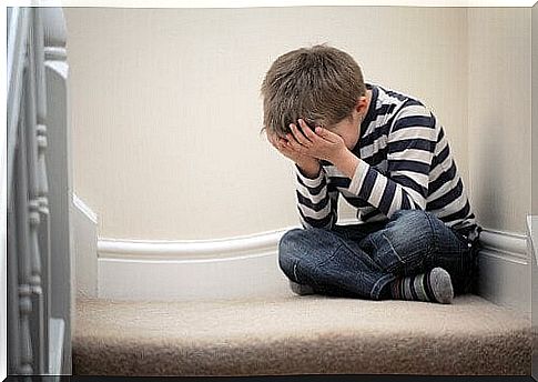 boy crying on the floor due to undermining in the family