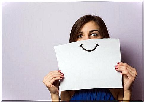 Woman with smile on paper uses positive language to be happy