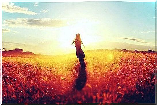 Woman without a family standing alone in field