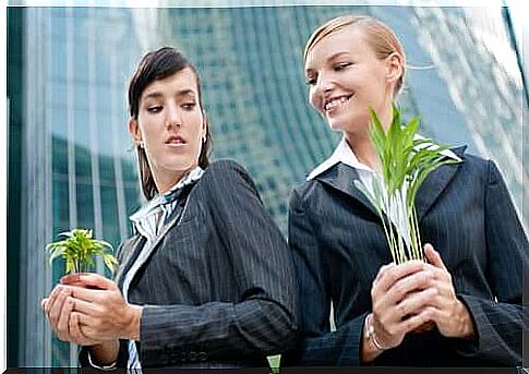 woman looking at colleague with envy